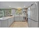 Well-lit modern kitchen featuring stainless steel appliances, ample counter space, and stylish tile flooring at 2312 Poinciana Rd, Winter Park, FL 32792