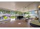 Spacious screened-in patio with outdoor seating and a view of the backyard play area at 2312 Poinciana Rd, Winter Park, FL 32792