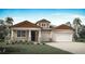 Charming single Gathering home featuring a two-car garage, manicured lawn and a welcoming front porch at 2639 Ginseng Ivy St, Apopka, FL 32703