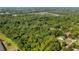 Overhead view displays the property surrounded by trees and greenery, set against a picturesque neighborhood backdrop at 287 Hilltop Dr, Longwood, FL 32750
