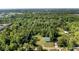 An aerial perspective outlining the property boundaries amidst a backdrop of dense trees and partial neighborhood views at 287 Hilltop Dr, Longwood, FL 32750