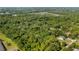 Aerial shot highlighting property lines within a wooded area, complemented by serene neighborhood views at 287 Hilltop Dr, Longwood, FL 32750