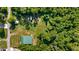 Aerial shot showcasing the property's green roof, nestled within lush surroundings, and outlining its secluded location at 287 Hilltop Dr, Longwood, FL 32750