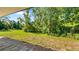Spacious backyard featuring a well-maintained lawn, framed by mature trees and lush foliage at 287 Hilltop Dr, Longwood, FL 32750