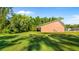 Exterior view of house with large lawn and trees at 287 Hilltop Dr, Longwood, FL 32750