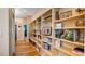 Hallway with custom built-in shelving providing storage and display, adding character and functionality to the home at 287 Hilltop Dr, Longwood, FL 32750