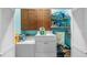 Functional laundry room with modern washer, dryer, and lots of storage shelves at 287 Hilltop Dr, Longwood, FL 32750