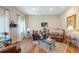 Cozy living room featuring hardwood floors, comfortable leather seating, and lots of natural light creating a warm space at 287 Hilltop Dr, Longwood, FL 32750
