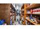 Walk-in pantry with wooden shelves stocked with food items, showcasing ample storage space and an HVAC system at 287 Hilltop Dr, Longwood, FL 32750