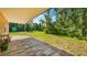 Relaxing backyard patio area with lush green lawn and a view of beautiful mature trees at 287 Hilltop Dr, Longwood, FL 32750