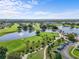 Aerial view of the golf course and clubhouse showcasing the surrounding green spaces and water features at 2926 Claremont Ct # Ge, Orlando, FL 32822