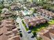 An aerial view showcases the townhome community's pool, parking, and lush green spaces at 2926 Claremont Ct # Ge, Orlando, FL 32822