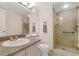 Bathroom with a glass enclosed shower and large vanity with ample storage at 2926 Claremont Ct # Ge, Orlando, FL 32822