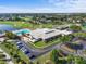 Aerial view of community clubhouse with pool, golf course, parking, and meticulously maintained landscaping under a sunny sky at 2926 Claremont Ct # Ge, Orlando, FL 32822