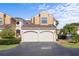 Charming townhouse with two-car garage, decorative lighting, and landscaped surroundings on a sunny day at 2926 Claremont Ct # Ge, Orlando, FL 32822