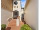 Inviting entrance with tiled steps, arched doorway, and charming exterior architecture at 2926 Claremont Ct # Ge, Orlando, FL 32822