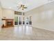 Bright living room featuring tiled floors, a fireplace, and double doors to the patio at 2926 Claremont Ct # Ge, Orlando, FL 32822