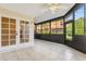 Enclosed patio featuring tile flooring, a ceiling fan, and large windows offering natural light and community views at 2926 Claremont Ct # Ge, Orlando, FL 32822