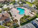 An aerial view of the community pool, featuring lounge chairs, lush landscaping, and a hot tub at 2926 Claremont Ct # Ge, Orlando, FL 32822