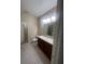 A well-lit bathroom features double sinks, granite countertops, a large mirror, and tile flooring at 2983 Boating Blvd, Kissimmee, FL 34746