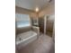 A bright bathroom showcases a soaking tub, a separate glass-enclosed shower, and a walk-in closet at 2983 Boating Blvd, Kissimmee, FL 34746
