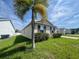Home exterior with lush green lawn and tidy landscaping beneath a sunny sky at 2983 Boating Blvd, Kissimmee, FL 34746
