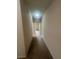 Neutral colored hallway with carpeted flooring throughout the home at 2983 Boating Blvd, Kissimmee, FL 34746