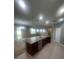 Modern kitchen with stainless steel appliances and connected living area at 2983 Boating Blvd, Kissimmee, FL 34746