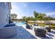 A stunning backyard with a sparkling pool, chic lounge furniture, and meticulously maintained landscaping, perfect for relaxation at 3126 Wolf Lake Ave, Apopka, FL 32712