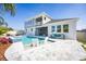 Expansive backyard featuring a modern pool with built-in seating, complemented by stylish outdoor furnishings and a cozy covered patio at 3126 Wolf Lake Ave, Apopka, FL 32712