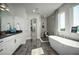 Elegant bathroom featuring a soaking tub, double vanity, and a walk-in shower at 3126 Wolf Lake Ave, Apopka, FL 32712