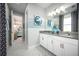 Well-lit bathroom with double vanity, decorative mirrors, and tiled floor at 3126 Wolf Lake Ave, Apopka, FL 32712