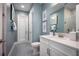Stylish bathroom with blue walls, white vanity, and modern fixtures at 3126 Wolf Lake Ave, Apopka, FL 32712