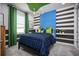 Unique bedroom with green and blue color scheme, stylish accents, and ample natural light at 3126 Wolf Lake Ave, Apopka, FL 32712