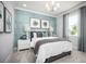 Calming bedroom with paneled accent wall, neutral tones, and soft natural light at 3126 Wolf Lake Ave, Apopka, FL 32712