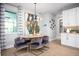 Bright dining area featuring modern chandelier, large window and unique abstract wall art at 3126 Wolf Lake Ave, Apopka, FL 32712