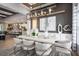 The dining room features modern lighting fixtures, light-colored walls, and stylish decor and furniture at 3126 Wolf Lake Ave, Apopka, FL 32712