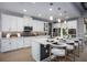 Bright kitchen with white cabinetry, stainless steel appliances, island seating, and modern pendant lighting at 3126 Wolf Lake Ave, Apopka, FL 32712