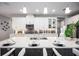 Bright kitchen features white cabinets, stainless steel appliances, pendant lighting, and seating at the island at 3126 Wolf Lake Ave, Apopka, FL 32712