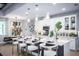 Well-lit kitchen features white cabinetry, a central island with seating, and modern appliances, adjoined to the dining area at 3126 Wolf Lake Ave, Apopka, FL 32712