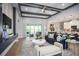 Open living room with modern decor, coffered ceilings, and sliding glass doors to the patio at 3126 Wolf Lake Ave, Apopka, FL 32712