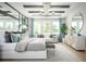 Serene main bedroom with tray ceiling, large windows, and stylish contemporary furnishings at 3126 Wolf Lake Ave, Apopka, FL 32712