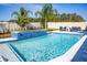 Sparkling in-ground pool with an attached spa, complemented by well-maintained landscaping and comfortable lounge seating at 3126 Wolf Lake Ave, Apopka, FL 32712