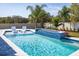 Beautiful in-ground swimming pool features a spa, in-water seating, and well-kept landscaping, creating a perfect backyard oasis at 3126 Wolf Lake Ave, Apopka, FL 32712