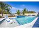 A stunning swimming pool area featuring in-water seating, a spa, and lush landscaping, creating a serene and inviting outdoor space at 3126 Wolf Lake Ave, Apopka, FL 32712