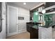 Modern wet bar with sleek black countertops and stylish geometric front design at 3126 Wolf Lake Ave, Apopka, FL 32712