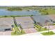 An aerial view showcasing the lush greenery and serene lake view surrounding the well-maintained single Gathering homes at 3280 Canna Lily Pl, Clermont, FL 34711
