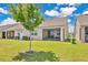 Well-maintained backyard with a tree and a covered lanai, perfect for outdoor entertaining and relaxation at 3280 Canna Lily Pl, Clermont, FL 34711