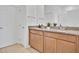 Bathroom featuring dual vanities with granite countertop and white doors at 3280 Canna Lily Pl, Clermont, FL 34711