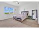 Bright bedroom with a large window, ceiling fan, and comfortable furnishings at 3280 Canna Lily Pl, Clermont, FL 34711